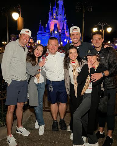 <p>Ben Higgins/ Instagram</p> Sarah Hyland and Wells Adams pose with their friends in front of Cinderella Castle