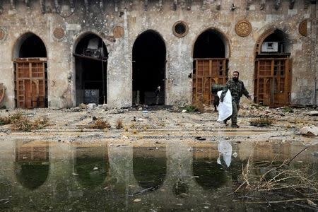 A member of forces loyal to Syria's President Bashar al-Assad walks inside the Umayyad mosque, in the government-controlled area of Aleppo, during a media tour, Syria December 13, 2016. REUTERS/Omar Sanadiki