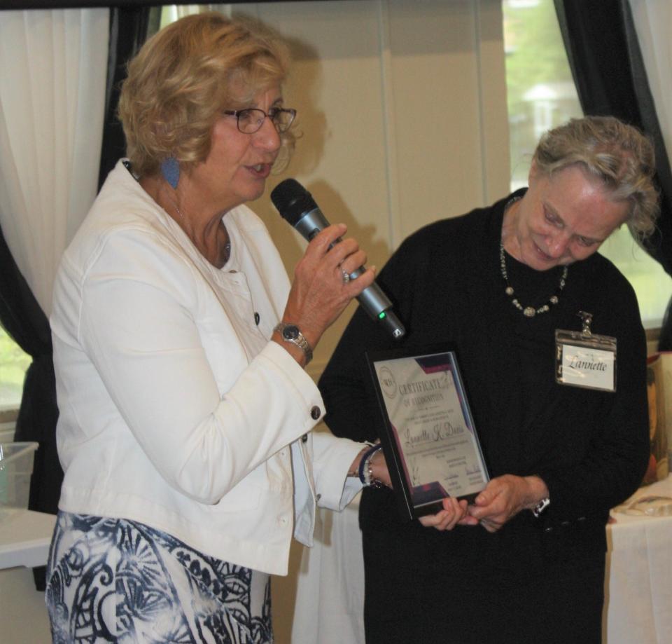 Past President Nancy Hafer (left) presents the inaugural Lannette K. Davis Women’s Impact Award to Davis.