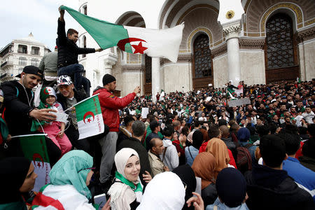 People carry national flags and banners during a protest calling on President Abdelaziz Bouteflika to quit, in Algiers, Algeria March 26, 2019. REUTERS/Ramzi Boudina