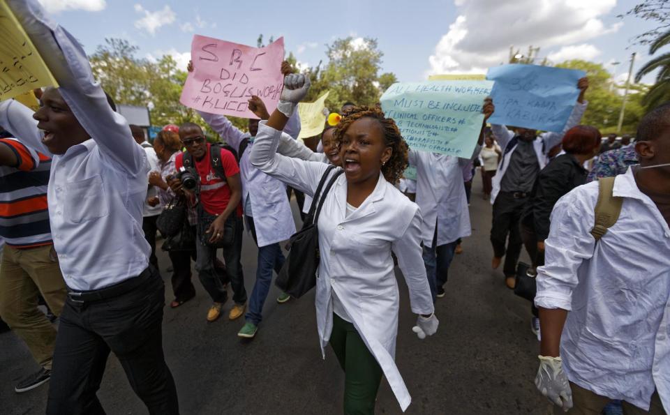 FILE - In this Thursday, Dec. 8, 2016 file photo, Kenyan nurses and other health-workers on strike demonstrate over low pay at Uhuru Park in downtown Nairobi, Kenya. A Kenyan judge Monday, Feb. 13, 2017 has jailed seven officials of the medics union for failing to call off a two-month strike by doctors at public hospitals that has seen at least a dozen die due to lack of medical care. (AP Photo/Ben Curtis, File)