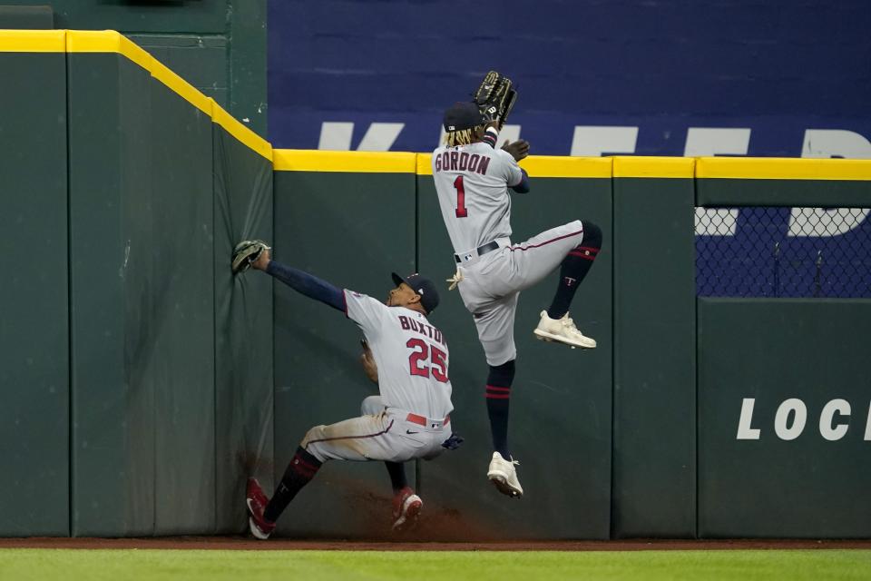 Minnesota Twins center fielder Byron Buxton (25) slams into the wall after catching a flyout by Texas Rangers' Marcus Semien after left fielder Nick Gordon (1) was unable to reach the ball in the fourth inning of a baseball game, Friday, July 8, 2022, in Arlington, Texas. (AP Photo/Tony Gutierrez)