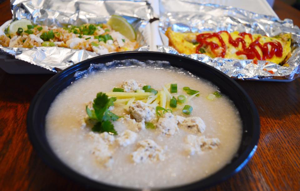 Rice pudding with tofu, front, fried rice with chicken, back left, and omelettes are some of the food created by JS Thai.