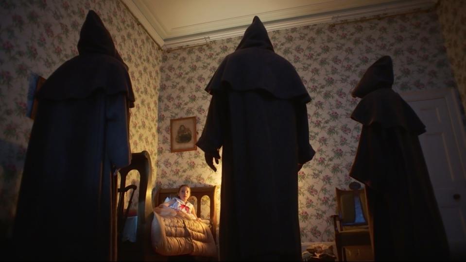 A young girl (Anya McKenna-Bruce) doesn't know what to do when three creepy hooded figures show up in her room in "The Banishing."