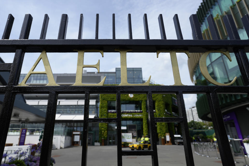 Through the gates at the All England Lawn Tennis and Croquet Club (AELTC), preparations are made ahead of the Wimbledon tennis championships in London, Monday, June 26, 2023. The Wimbledon tennis championships start on Monday July 3 and run for two weeks. (AP Photo/Kirsty Wigglesworth)