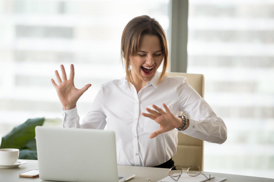 Excited happy employee looking at wristwatch satisfied with meeting deadline finished work day in time, cheerful businesswoman checking time feeling motivated waiting for leaving office on friday