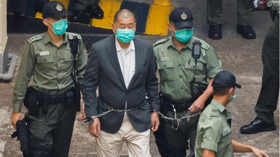 Media mogul Jimmy Lai Chee-ying, founder of Apple Daily, walks to a prison van to head to court, after being charged under the national security law, in Hong Kong, China December 12, 2020.