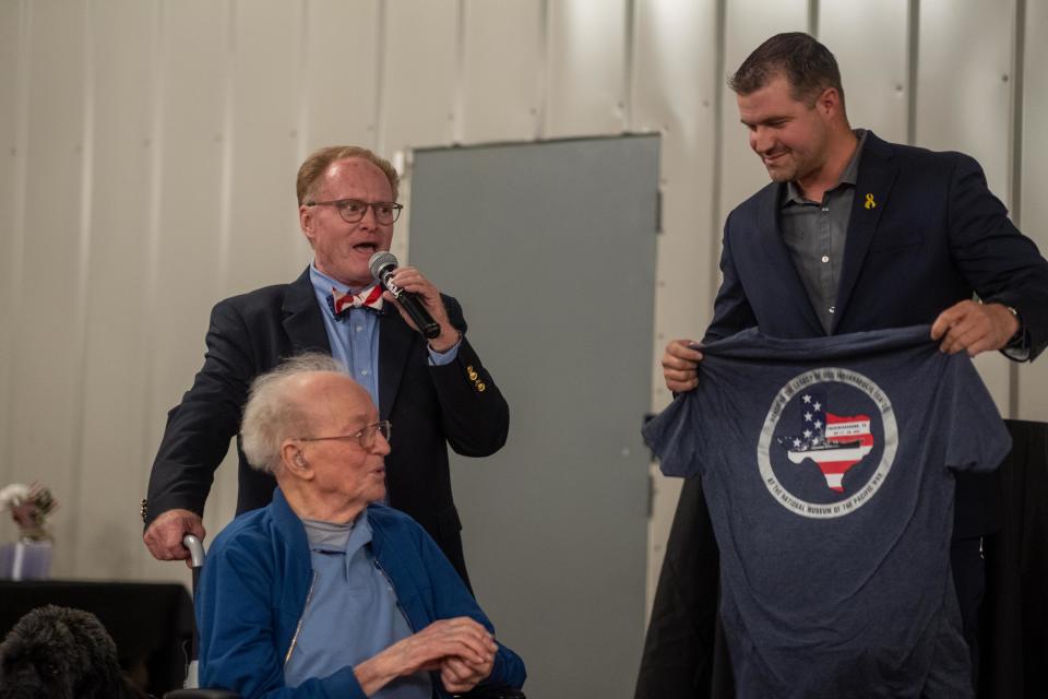 Blake Siebrecht of BOOM receives a token of tanks from World War II Veteran and oldest survivor of the U.S.S. Indianapolis Saturday at the Armed Forces Day banquet.