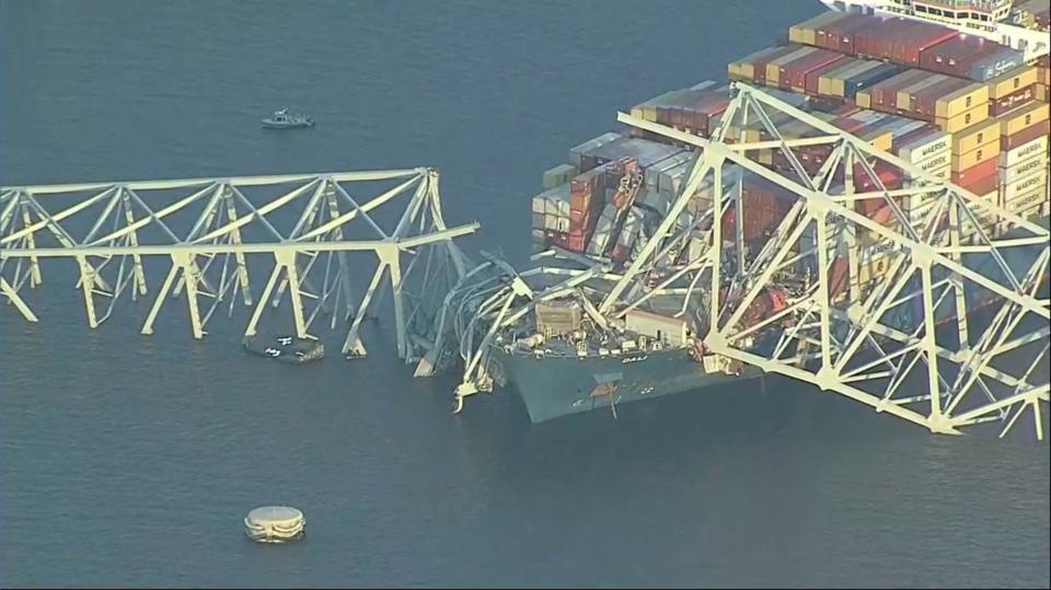 Parts of the Francis Scott Key Bridge remain after a container ship collided with a support Tuesday, March 26, 2024 in Baltimore. The major bridge in Baltimore snapped and collapsed after a container ship rammed into it early Tuesday, and several vehicles fell into the river below. Rescuers were searching for multiple people in the water. (WJLA via AP)