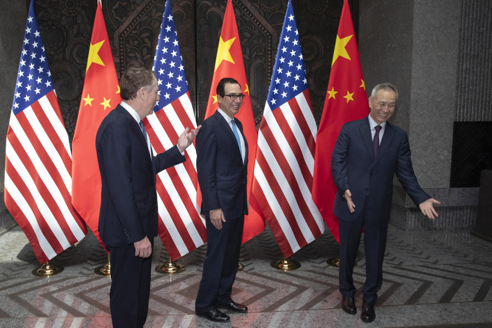 CORRECTS SPELLING TO STEVEN INSTEAD OF STEVE - Chinese Vice Premier Liu He, right, welcomes U.S. Trade Representative Robert Lighthizer, left, and Treasury Secretary Steve, Mnuchin, center before holding talks at the Xijiao Conference Center in Shanghai Wednesday, July 31, 2019. (AP Photo/Ng Han Guan, Pool)