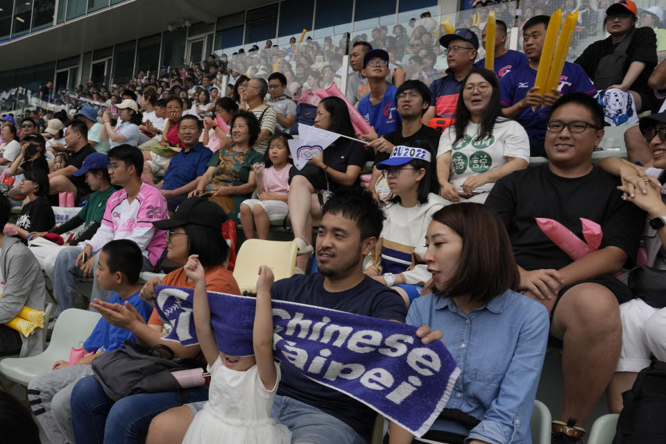Taiwanese supporters cheer for the Taiwan baseball team during a stage group round B Baseball Men game against Hong Kong for the 19th Asian Games in Hangzhou, China on Tuesday, Oct. 3, 2023. At the Asian Games China has been going out of its way to be welcoming to the Taiwanese athletes, as it pursues a two-pronged strategy with the goal of taking over the island, which involves both wooing its people while threatening it militarily. (AP Photo/Ng Han Guan)