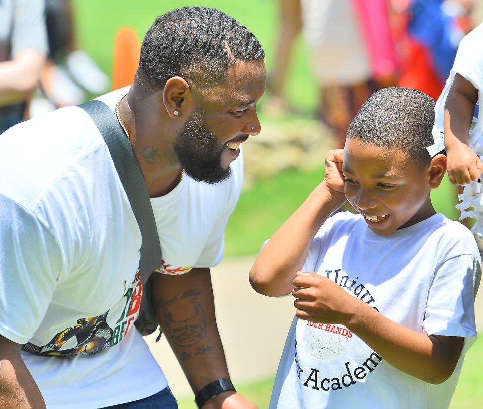 Raysean Wintz of Greenville, S.C., plays with his son Parker Wintz, 6, at the Juneteenth GVL Mega Fest in Falls Park on June 18.