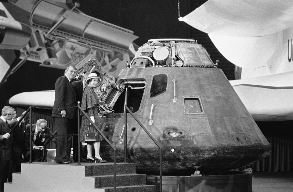 Britain's Queen Elizabeth II looks inside the Apollo 14 command module, a spaceship that visited the Moon in February 1971, during her tour of Rockwell International plant, Feb. 28, 1983 in Downey, Calif. (AP Photo)