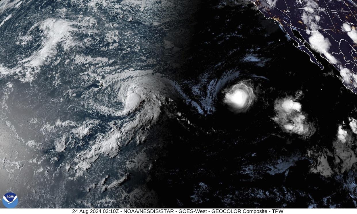 A satellite image by the National Oceanic and Atmospheric Administration (NOAA) shows Tropical Storm Hone, left, and Hurricane Gilma southeast of Hawaii on Friday. 