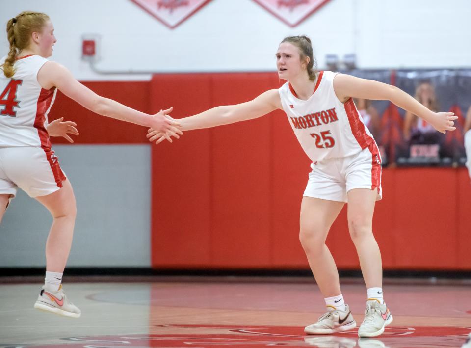 Morton's Abby VanMeenan, right, congratulates teammate Addy Engel on a score against Washington in the second half of their Mid-Illini Conference basketball game Tuesday, Feb. 6, 2024 in Morton. The Potters clinched the conference title with a 45-41 victory.