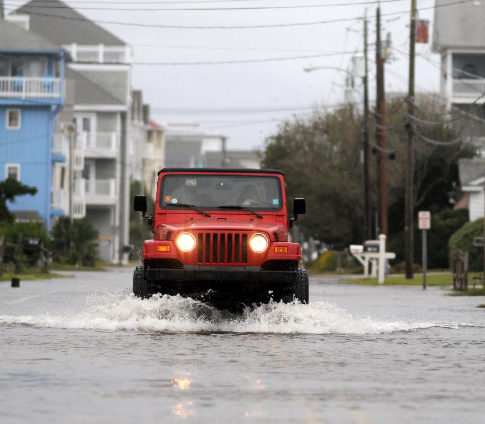 A Jeep drives along a flooded Canal Drive in Carolina Beach back in 2015.