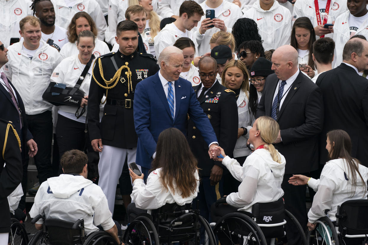 President Joe Biden greets members of Team USA during an event with the Tokyo 2020 Summer Olympic and Paralympic Games, and Beijing 2022 Winter Olympic and Paralympic Games, on the South Lawn of the White House, Wednesday, May 4, 2022, in Washington. (AP Photo/Evan Vucci)