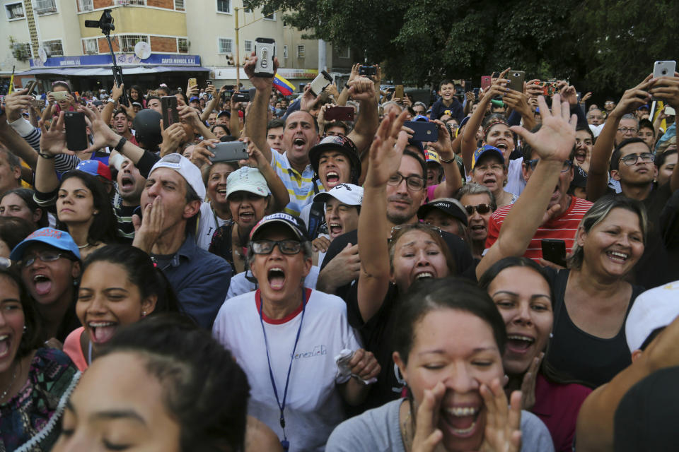 Supporters of National Assembly President Juan Guaido, who declared himself interim president of Venezuela, shout slogans against Venezuela's President Nicolas Maduro during a rally in Caracas, Venezuela, Tuesday, March 12, 2019. Guaido has declared himself interim president and demands new elections, arguing that President Nicolas Maduro's re-election last year was invalid.(AP Photo/Fernando Llano)