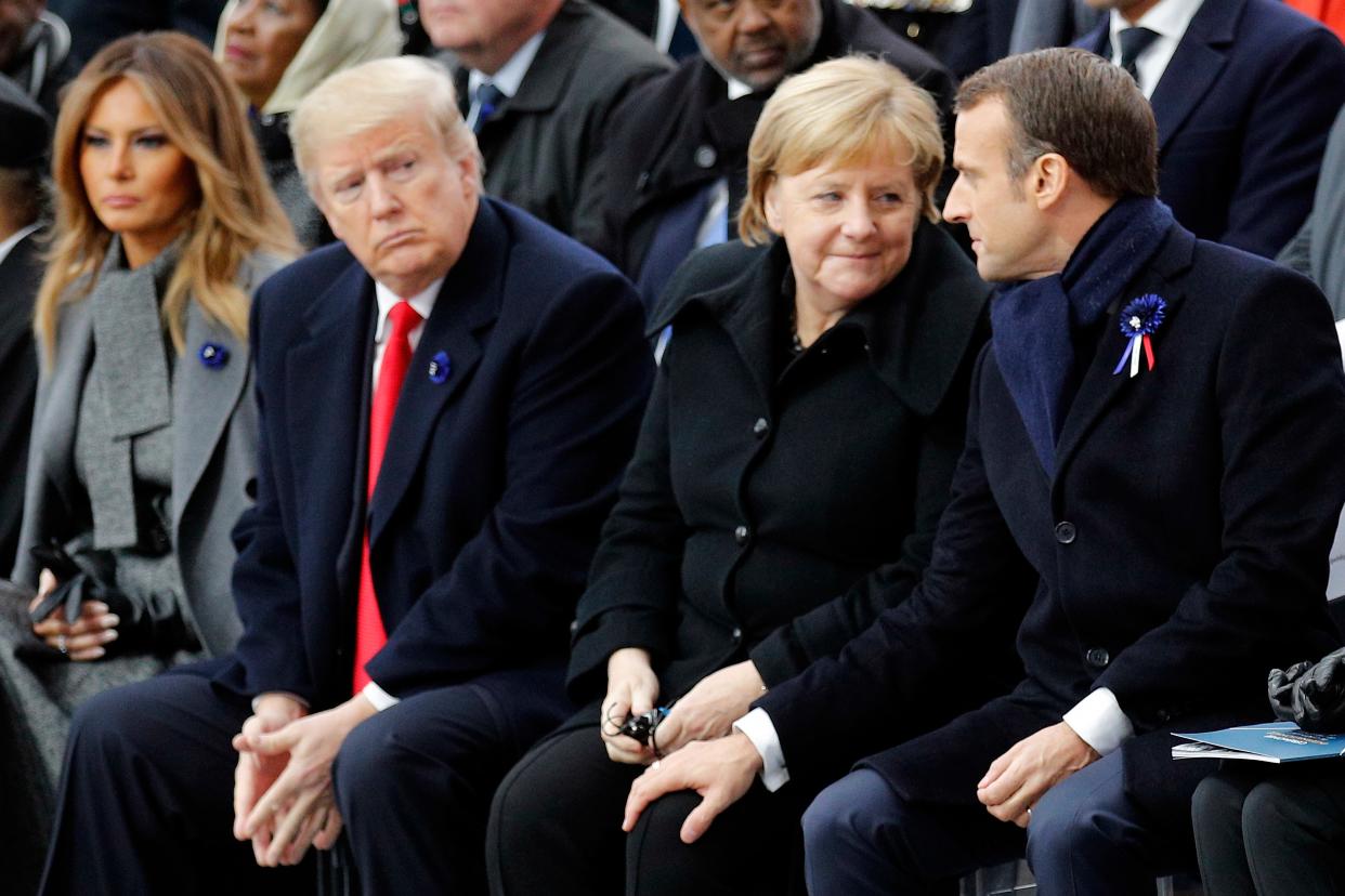 Former President Donald Trump looks on as French President Emmanuel Macron chats with German Chancellor Angela Merke in November 2018 in Paris. Over 60 heads of state and government took part in a solemn ceremony at the Tomb of the Unknown Soldier to honor those who died in World War One.