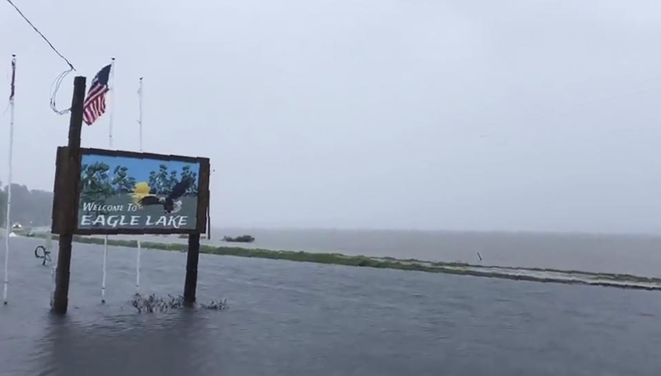 This Sunday, July 14, 2019, image made from a cellphone video provided by the Mississippi Governor's Office shows the flooded welcome sign at the entrance to Eagle Lake community near Vicksburg, Miss. In a Monday, July 15, posting of the short video on Twitter, Gov. Phil Bryant made reference that "the South Delta has become an ocean," with the additional rainfall from Tropical Depression Barry, while calling on the federal government to build pumps to drain water from the confluence of the Yazoo and Mississippi Rivers. (Bobby Morgan/Office of Mississippi Gov. Phil Bryant via AP)