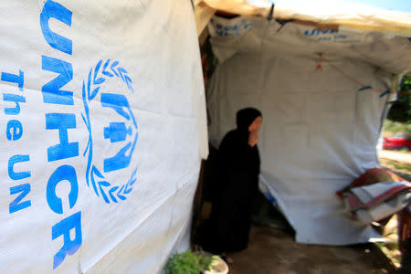 A Syrian refugee woman stands outside a tent at a refugee camp in Zahrani town, southern Lebanon June 13, 2018. REUTERS/Ali Hashisho