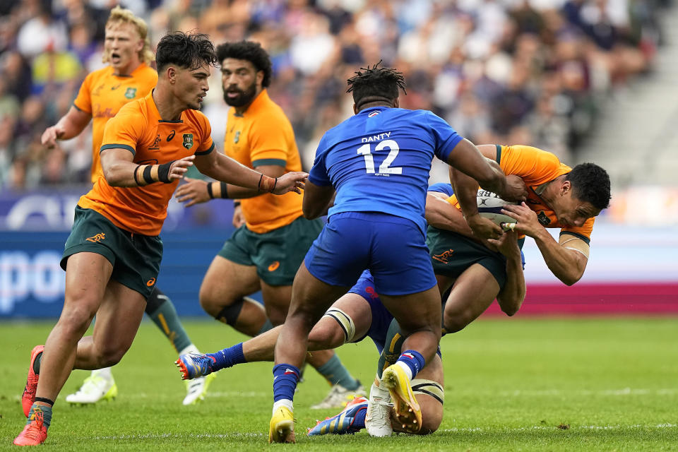 Australia's Lalakai Foketi is tackled during the International Rugby Union World Cup warm-up match between France and Australia at the Stade de France stadium in Saint Denis, outside Paris, Sunday, Aug. 27, 2023. (AP Photo/Michel Euler)