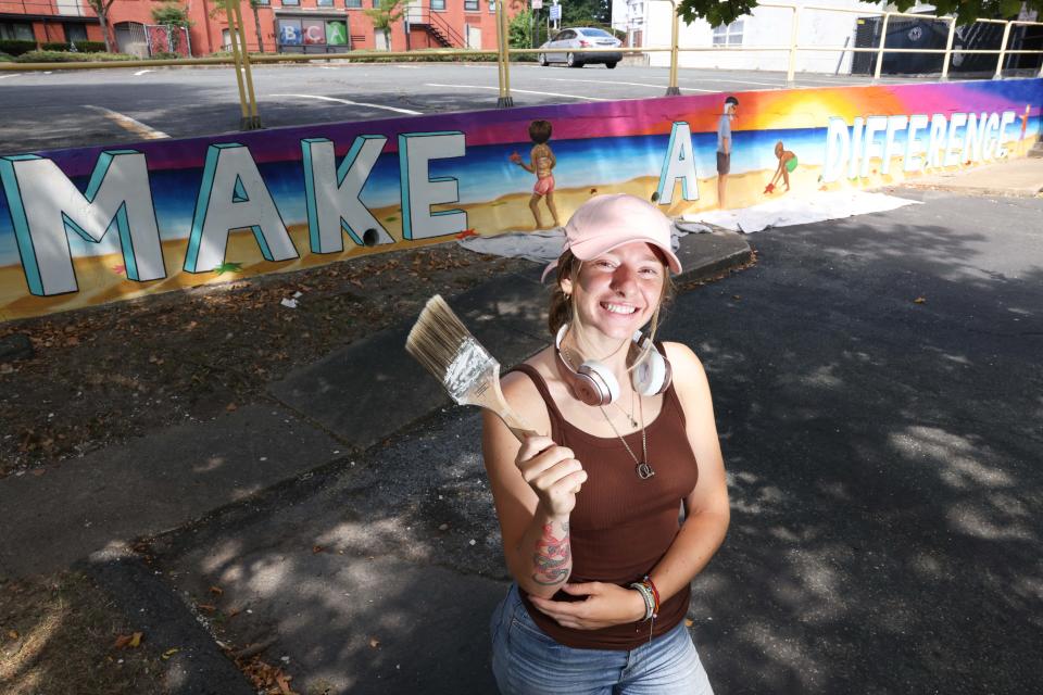 Artist Jessica Picanzo, 22, of Brockton, makes this mural called 'Make A Difference' outside Brockton Community Access on Friday, July 29, 2022.  