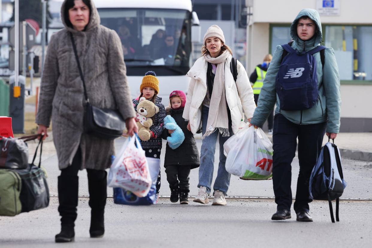 Image: Women and children fleeing war in Ukraine cross the border into Poland at Medyka on March 3, 2022. (Sean Gallup / Getty Images)