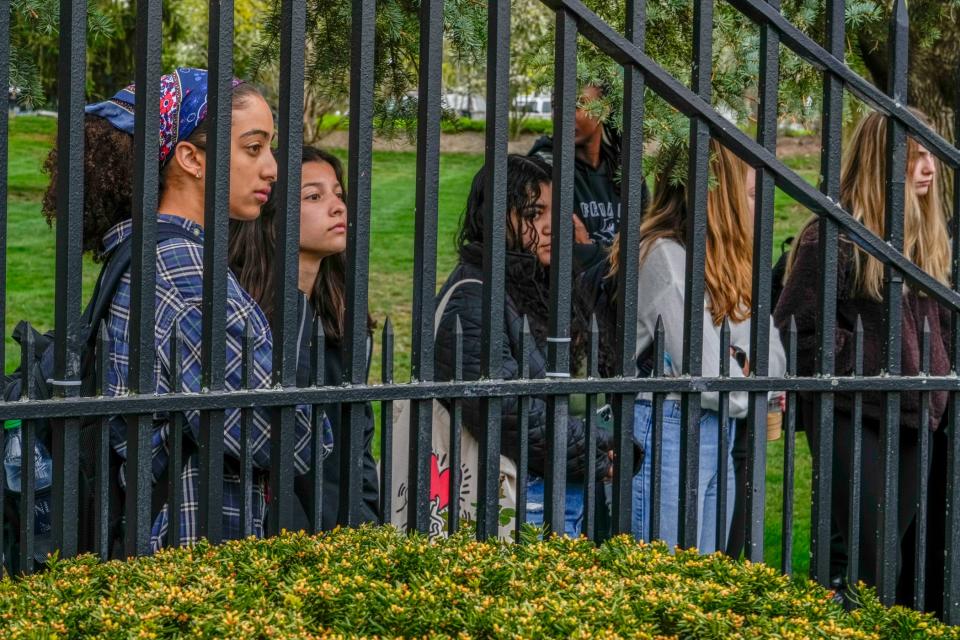 Supporters of Providence College Public Safety Lt. John Dunbar listen to his allegations of racial discrimination and harassment at a news conference Tuesday.