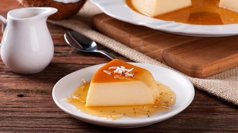 Flan slice on plate with shredded coconut