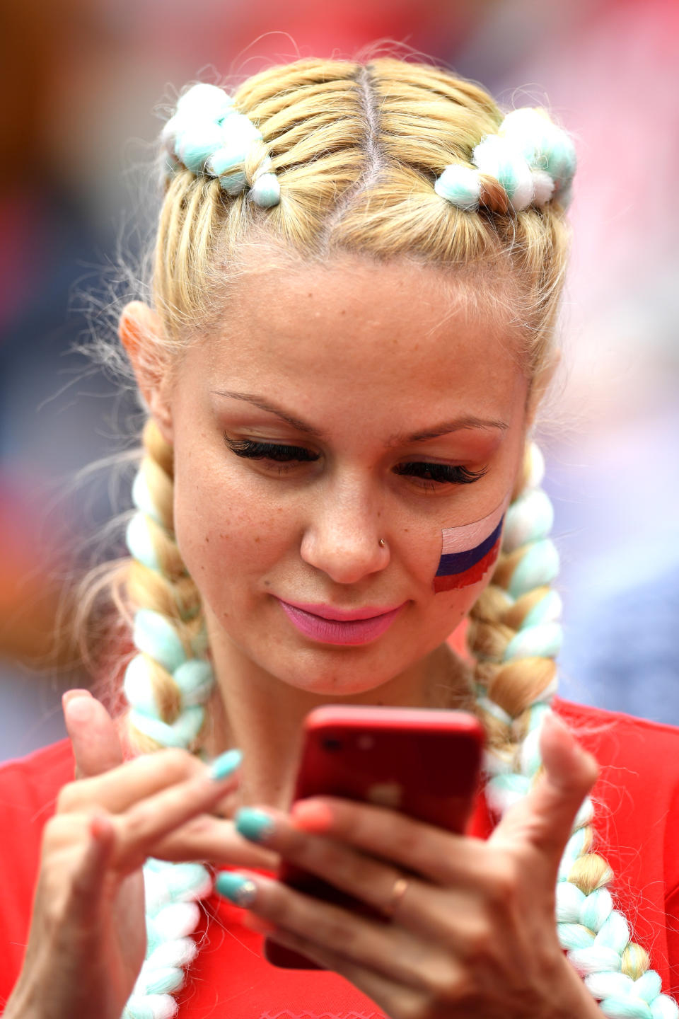 <p>A Russian fan looks at her smartphone prior to the 2018 FIFA World Cup Russia Group A match between Russia and Saudi Arabia at Luzhniki Stadium on June 14, 2018 in Moscow, Russia. (Photo by Matthias Hangst/Getty Images) </p>