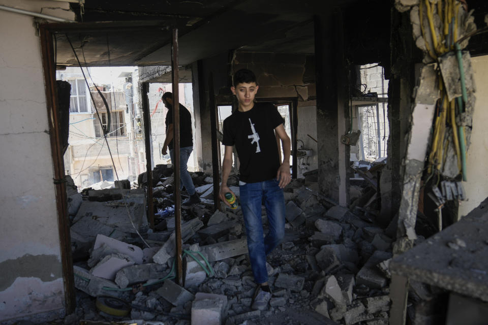 Palestinians inspect the destruction following an Israeli operation in Nur Shams refugee camp, near the West Bank town of Tulkarem, Monday, July 1, 2024. Palestinian health officials say a woman and a teenager were shot and killed, and four people were wounded by Israeli forces during a raid in the northern West Bank. (AP Photo/Majdi Mohammed)