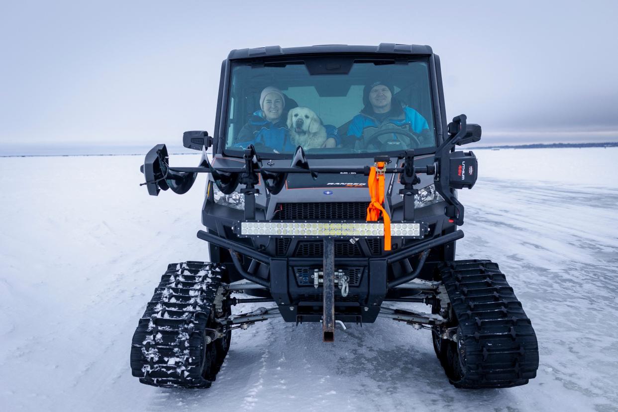 People haul an ice house using a SnoBear, an ice fishing recreational vehicle, on The Northwest Angle ice road at Lake of the Woods on Jan. 17, 2022.