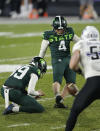 Michigan State's Matt Coghlin (4) kicks a field goal as Bryce Baringer, left, holds during the fourth quarter of an NCAA college football game against Northwestern, Saturday, Nov. 28, 2020, in East Lansing, Mich. (AP Photo/Al Goldis)