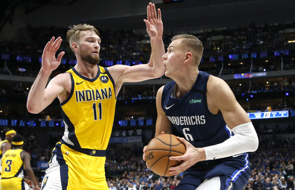 Indiana Pacers forward Domantas Sabonis (11) guards Dallas Mavericks forward Kristaps Porzingis (6) during the second half of an NBA basketball game, Sunday, March 8, 2020, in Dallas. The Pacers won 112-109. (AP Photo/Ron Jenkins)