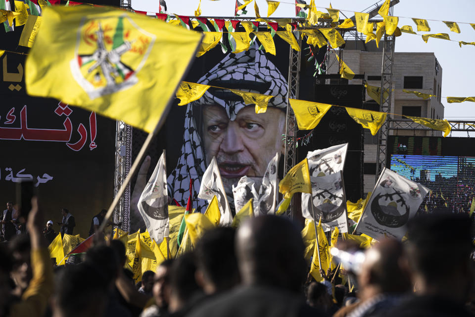 Palestinians chant slogans and wave yellow Fatah movement flags during a rally marking the 18th anniversary of the death of Fatah founder and Palestinian Authority leader Yasser Arafat in Gaza City, Thursday, Nov. 10, 2022. (AP Photo/Fatima Shbair)