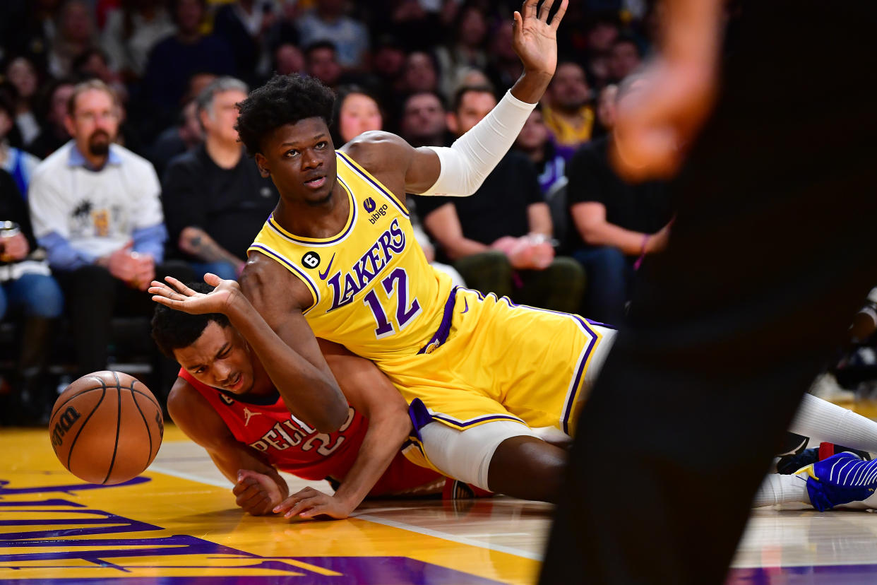 Feb 15, 2023; Los Angeles, California, USA; Los Angeles Lakers center Mo Bamba (12) collides with New Orleans Pelicans guard Trey Murphy III (25) while playing for te ball during the second half at Crypto.com Arena. Mandatory Credit: Gary A. Vasquez-USA TODAY Sports