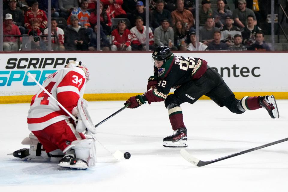 Detroit Red Wings goaltender Alex Lyon (34) makes a save against Arizona Coyotes center Logan Cooley (92) in the first period at Mullett Arena in Tempe, Arizona, on Friday, March 8, 2024.