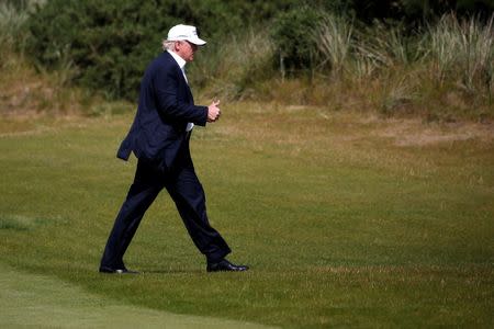 Republican presidential candidate Donald Trump walks after landing on the golf course at his Trump International Golf Links in Aberdeen, Scotland, June 25, 2016. REUTERS/Carlo Allegri