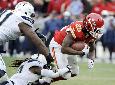 Nov 24, 2013; Kansas City, MO, USA; Kansas City Chiefs running back Jamaal Charles (25) is tackled by San Diego Chargers defensive back Jahleel Addae (37) and defensive end Kendall Reyes (91) in the second half at Arrowhead Stadium. San Diego won 41-38. Mandatory Credit: John Rieger-USA TODAY Sports