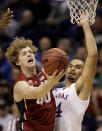 Stanford's John Gage (40) shoots under pressure from Kansas's Perry Ellis, right, during the first half of a third-round game at the NCAA college basketball tournament Sunday, March 23, 2014, in St. Louis. (AP Photo/Charlie Riedel)