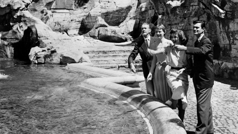 "Three Coins in the Fountain" cast members throw their loose change in Rome's famed Trevi fountain while on-location for the movie in 1954. - 20th Century Fox/Courtesy Everett Collection