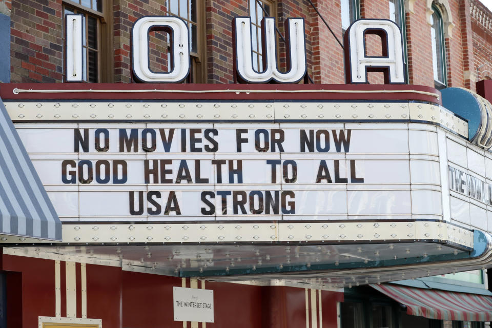 FILE - This Wednesday, April 1, 2020 file photo shows the marquee for the Iowa Theater, closed in response to the COVID-19 coronavirus outbreak, on John Wayne Drive in Winterset, Iowa. The $349 billion program approved by Congress to help small businesses devastated by the coronavirus outbreak is expected to be spent quickly after it opens on Friday, April 3, 2020, in part because large franchisees and multi-property companies are poised to claim a disproportionate share as soon as the money starts flowing. (AP Photo/Charlie Neibergall)