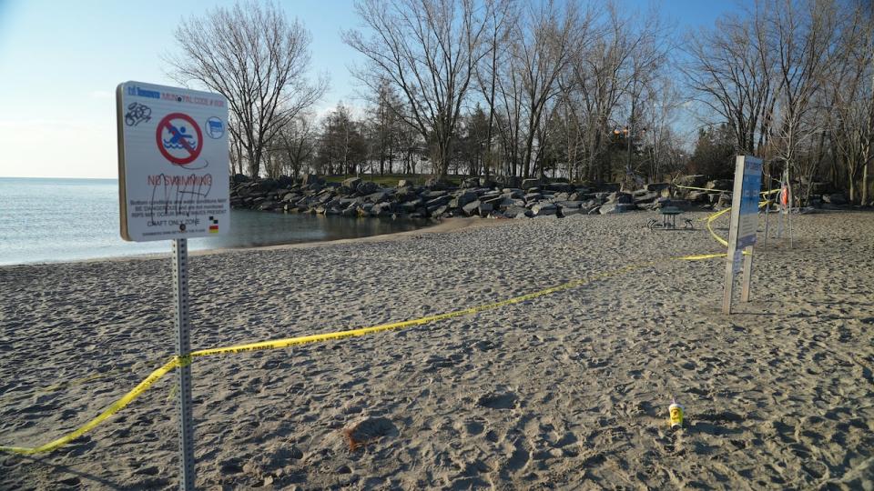 Police taped off a stretch of Ashbridges Bay where a teen boy disappeared in the water on Sunday. His body was recovered on Monday. (Paul Smith/CBC - image credit)