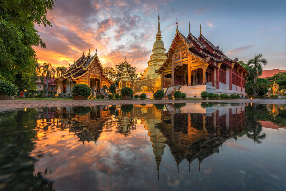 The reflection of temples in the water at sunset