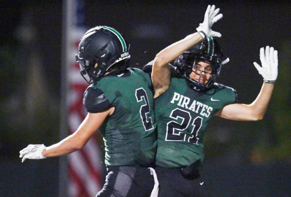 Reedley’s Malachi Rios, left, celebrates Adrian Morales’ two point conversion, right, against Roosevelt Friday night, Aug. 25, 2023 in Reedley.