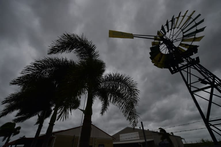 Ayr in far north Queensland is deserted as Cyclone Debbie hit the coastline, cutting power, damaging buildings and uprooting trees