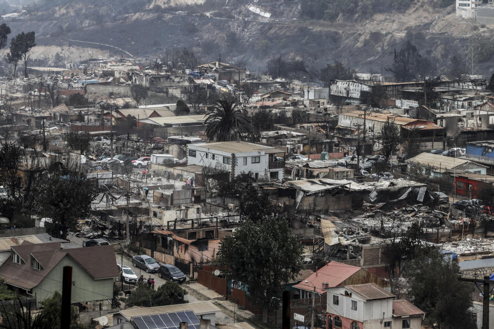 Rubble sits on burnt-out house after forest fires reached Vina del Mar, Chile, Sunday, Feb. 4, 2024. (AP Photo/Cristobal Basaure)