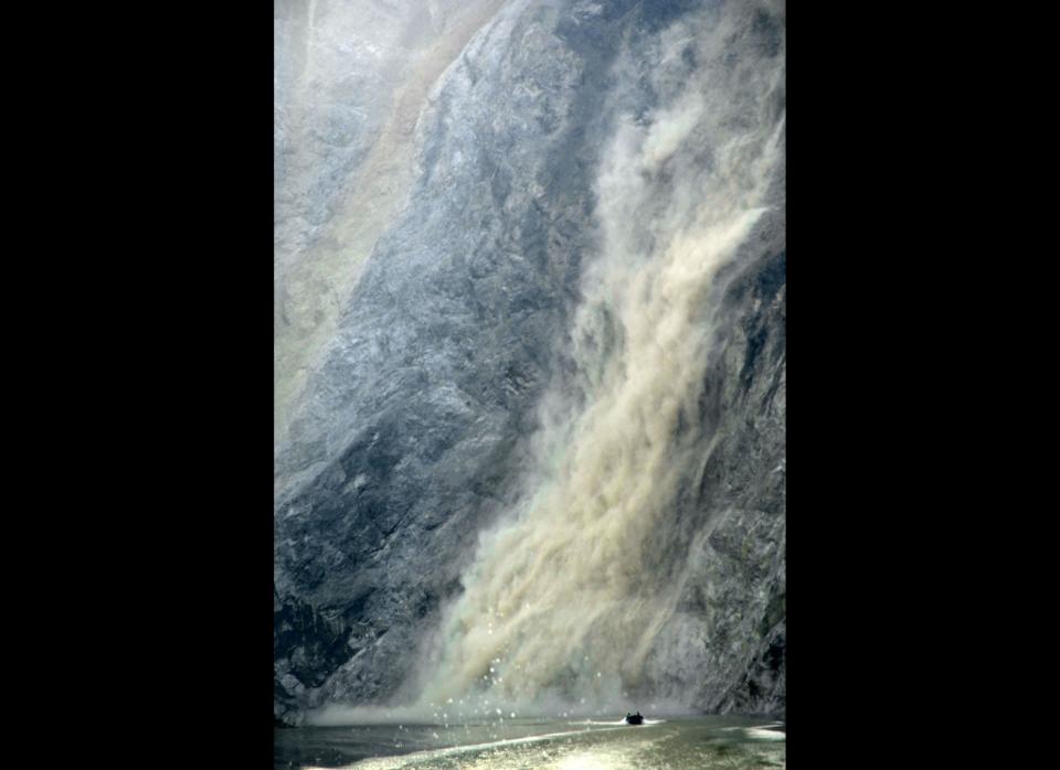  People flee a landslide on a speed boat as a result of aftershocks on May 19, 2008 in Yingxiu, Sichuan Province, China. (Photo by Chen Yuxiao/ChinaFotoPress)