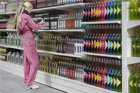 A model presents a creation by German designer Karl Lagerfeld as part of his Fall/Winter 2014-2015 women's ready-to-wear collection for French fashion house Chanel at the Grand Palais transformed into a "Chanel Shopping Center" during Paris Fashion Week March 4, 2014. REUTERS/Stephane Mahe